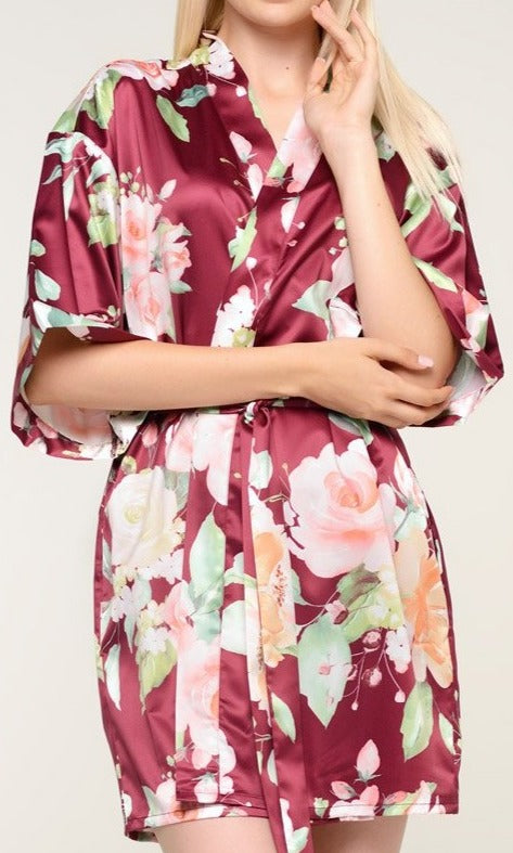With varying shades of pinks and oranges on a red wine background, style is always in bloom with this premium satin robe. The feminine pattern has a series of roses in soft pastels repeating throughout the garment for a beautiful chic piece. Wear it as a stylish cover or on the big day when you prepare for your wedding. It’s a beautiful gift that any bride-to-be or bridesmaid will appreciate. Customize it for a gift that she’ll be sure to treasure.