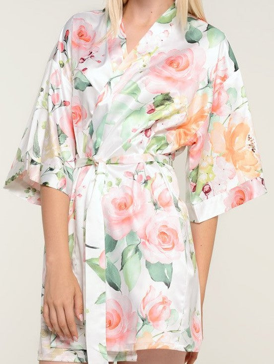 With varying shades of pinks and oranges on a bridal white background, style is always in bloom with this premium satin robe. The feminine pattern has a series of roses in soft pastels repeating throughout the garment for a beautiful chic piece. Wear it as a stylish cover or on the big day when you prepare for your wedding. It’s a beautiful gift that any bride-to-be or bridesmaid will appreciate. Customize it for a gift that she’ll be sure to treasure.